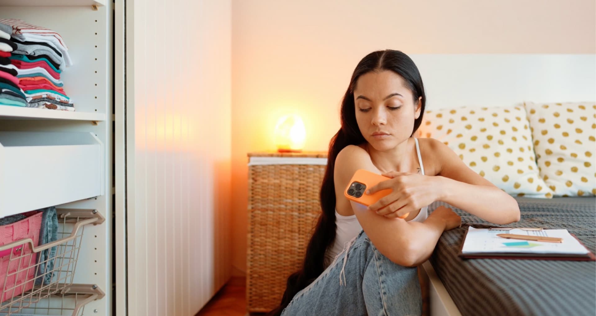 A woman using her phone to scan an implant in her arm.