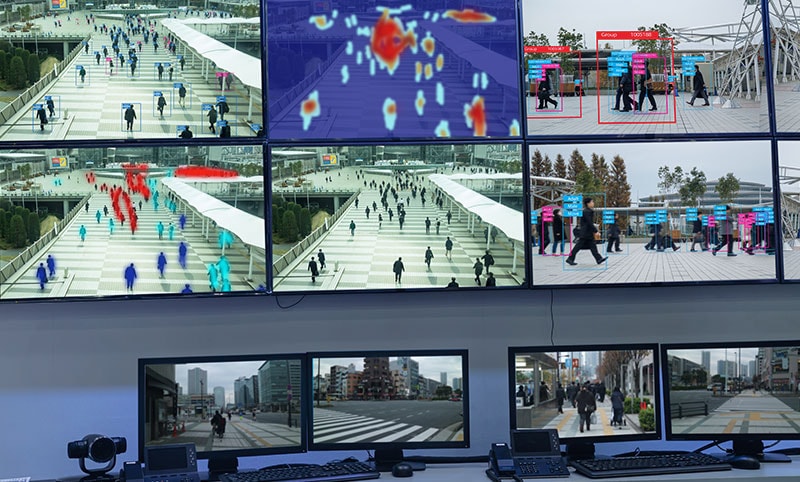 a wall with multiple screens on it showing different security camera feeds