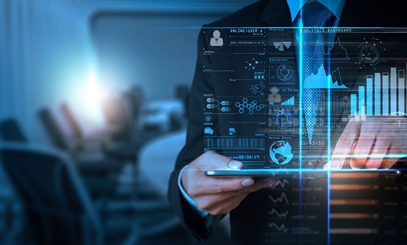 A close up of a man holding a laptop with data visualized coming out of the laptop